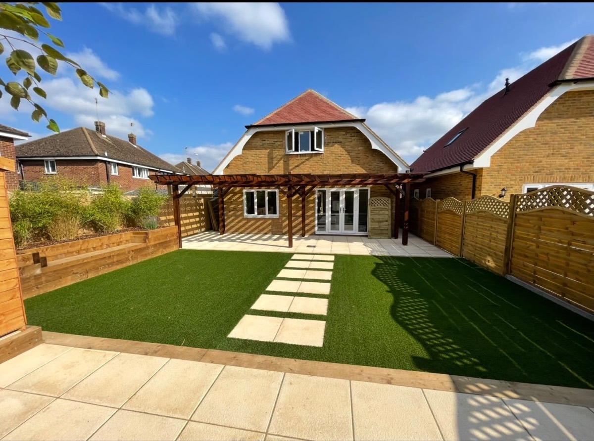 Rear garden with paving, lawn and timber pergola