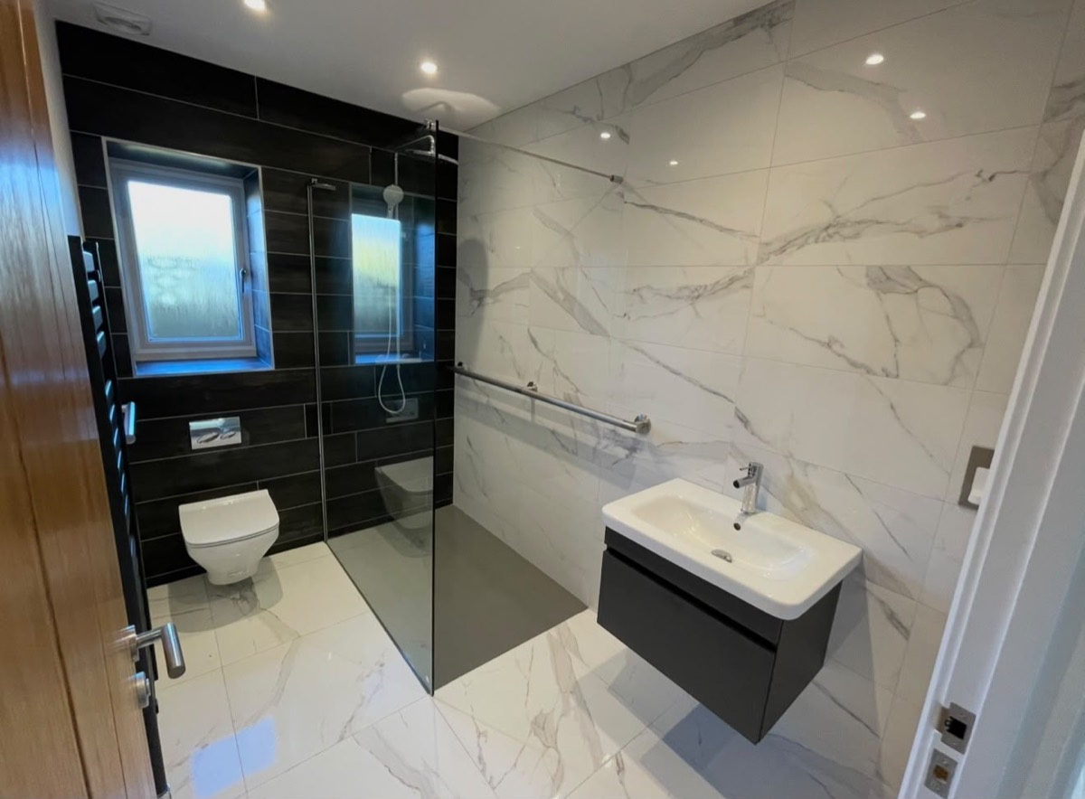 Accessible wet room with walk in shower and grab rail