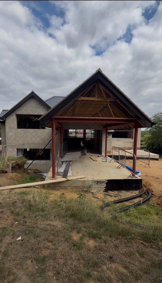 Steel porch frame and blockwork shell during construction