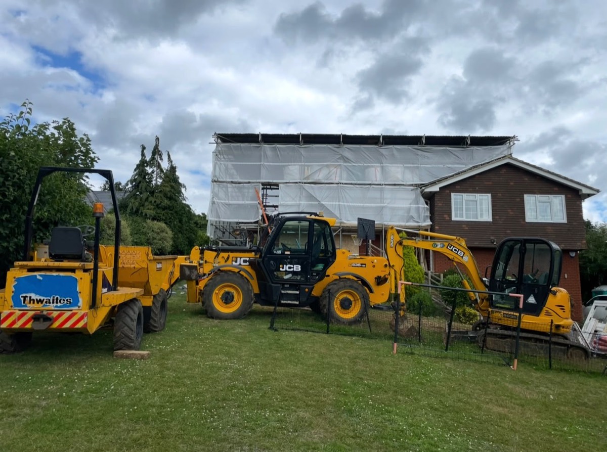GPF plant on site: dumper, telehandler and excavator beside a scaffolded house