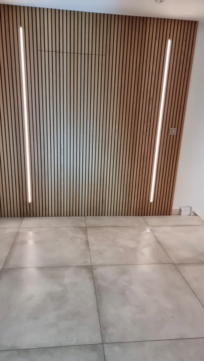 Timber slatted feature wall with integrated vertical LED lighting