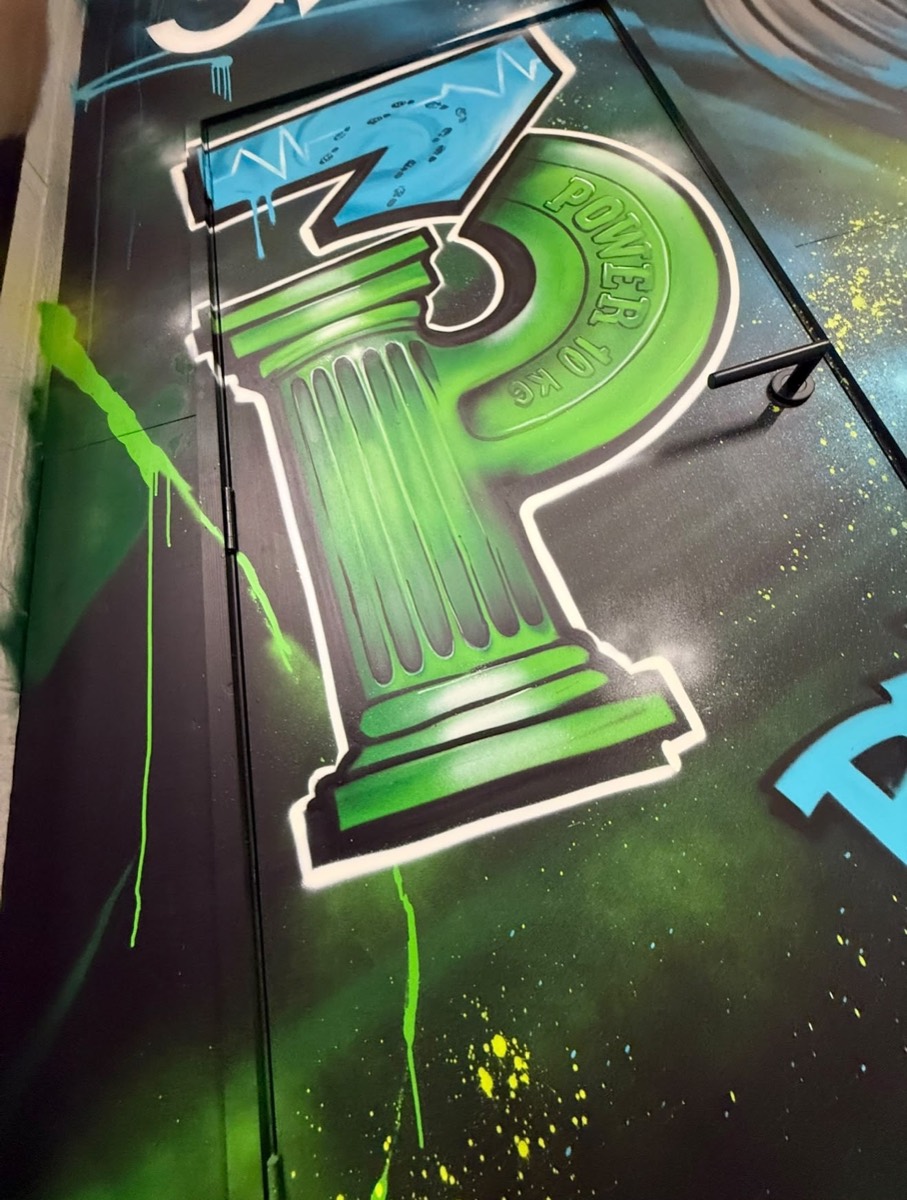 Three Pillars 3P logo graffiti on the gym wall